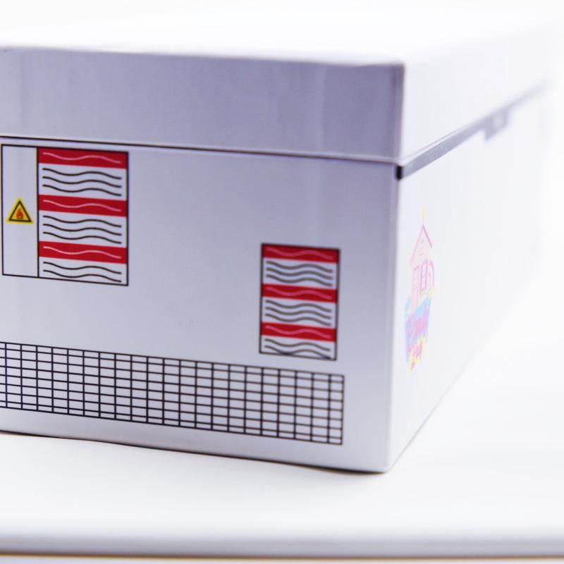 White rectangular box with red and black patterned labels and a grid design on the side.