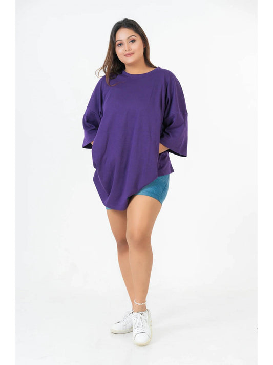 Purple relaxed fit oversized t-shirt with dropped shoulders worn over teal shorts.