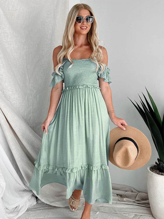 Light green backless midi dress with thin shoulder straps and ruffled hem.