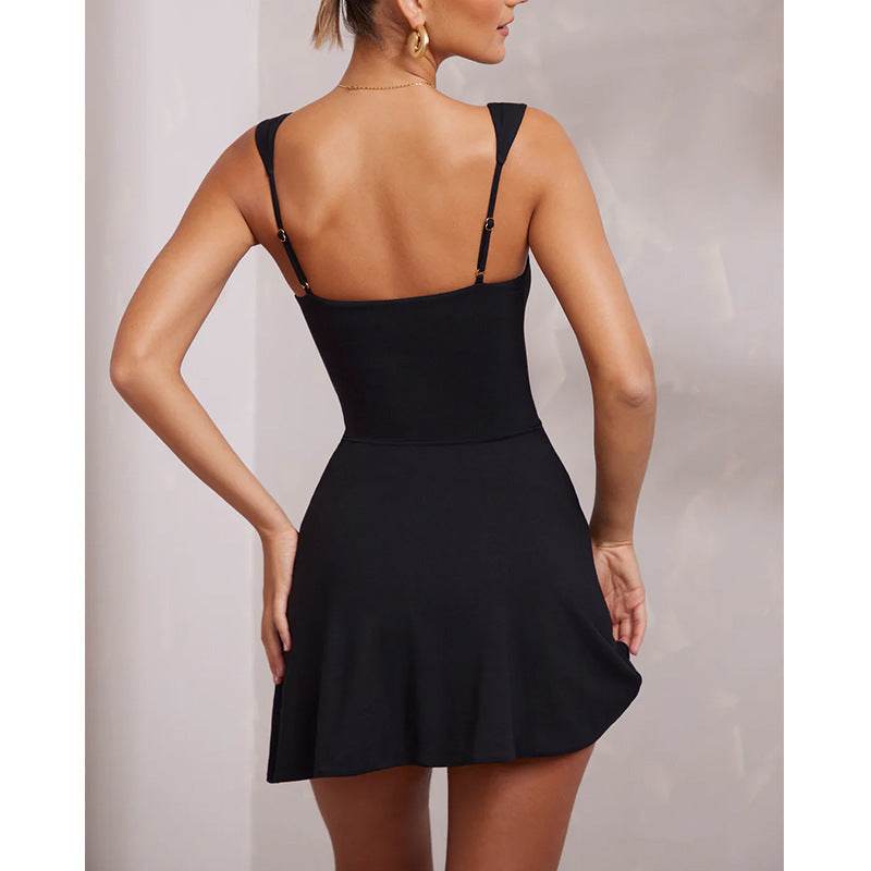 Black backless mini dress with spaghetti straps and fitted waist, flared hem.
