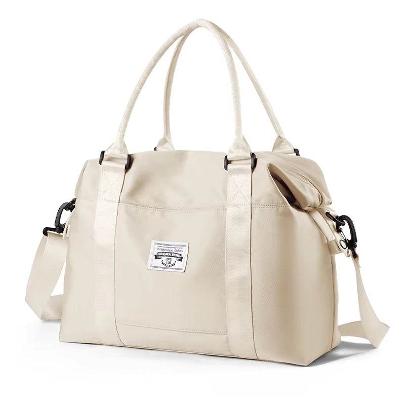 Cream white waterproof duffel bag with dual handles and adjustable shoulder strap, front logo patch.