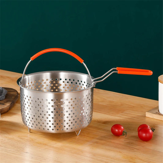 Metal colander with orange handles on a wooden surface with tomatoes
