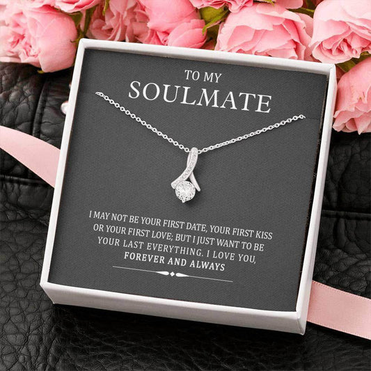 Silver infinity heart pendant necklace on black card with "To My Soulmate" message and pink roses background.