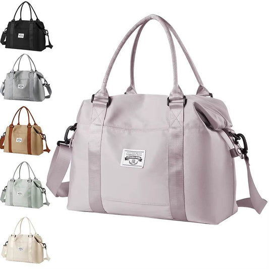 Light purple waterproof duffel bag with front patch logo, dual handles, and adjustable shoulder strap.