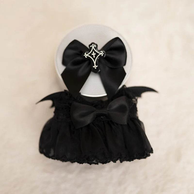 Black lace doll dress with large bow and small bat wings, paired with black bow headband featuring silver cross charm.