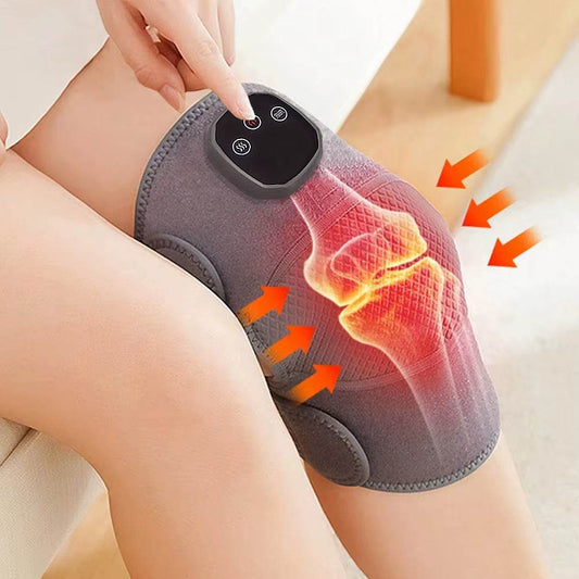 Grey fabric knee massager with adjustable heat and vibration controls on a bent leg.
