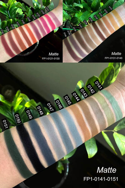 Arm swatches of matte eyeshadow shades ranging from warm browns and reds to cool blues and greys, numbered with labels on a.