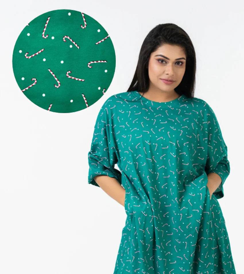 Green relaxed fit t-shirt with all-over white and red candy cane print and short sleeves.