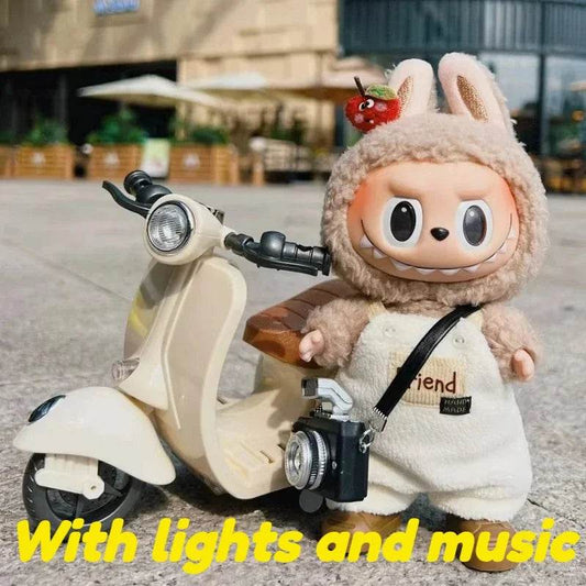 Beige mini electric motorcycle toy with round headlight and cute doll in fuzzy bunny outfit holding camera.