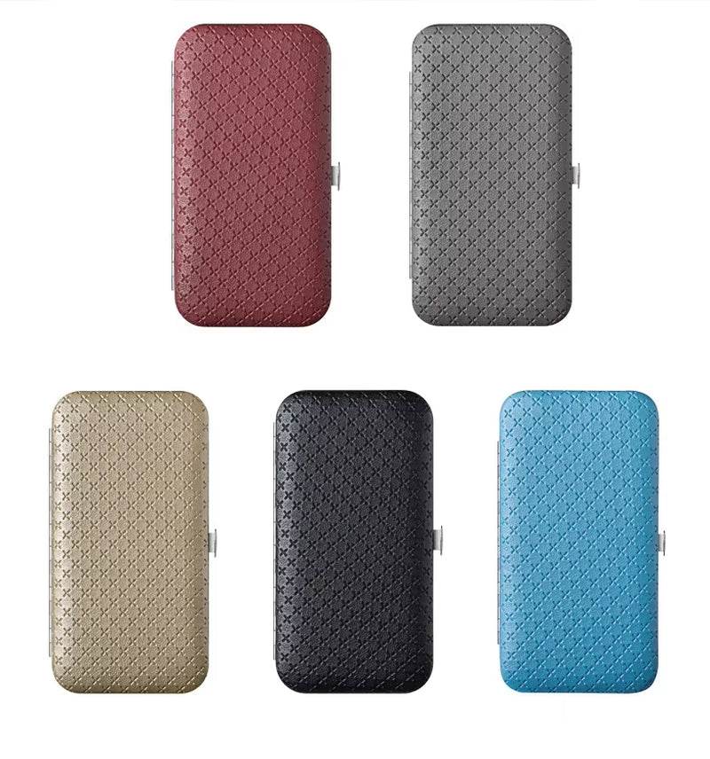 Five rectangular travel grooming kit cases in burgundy, gray, beige, black, and blue with textured surfaces and metal clasps.