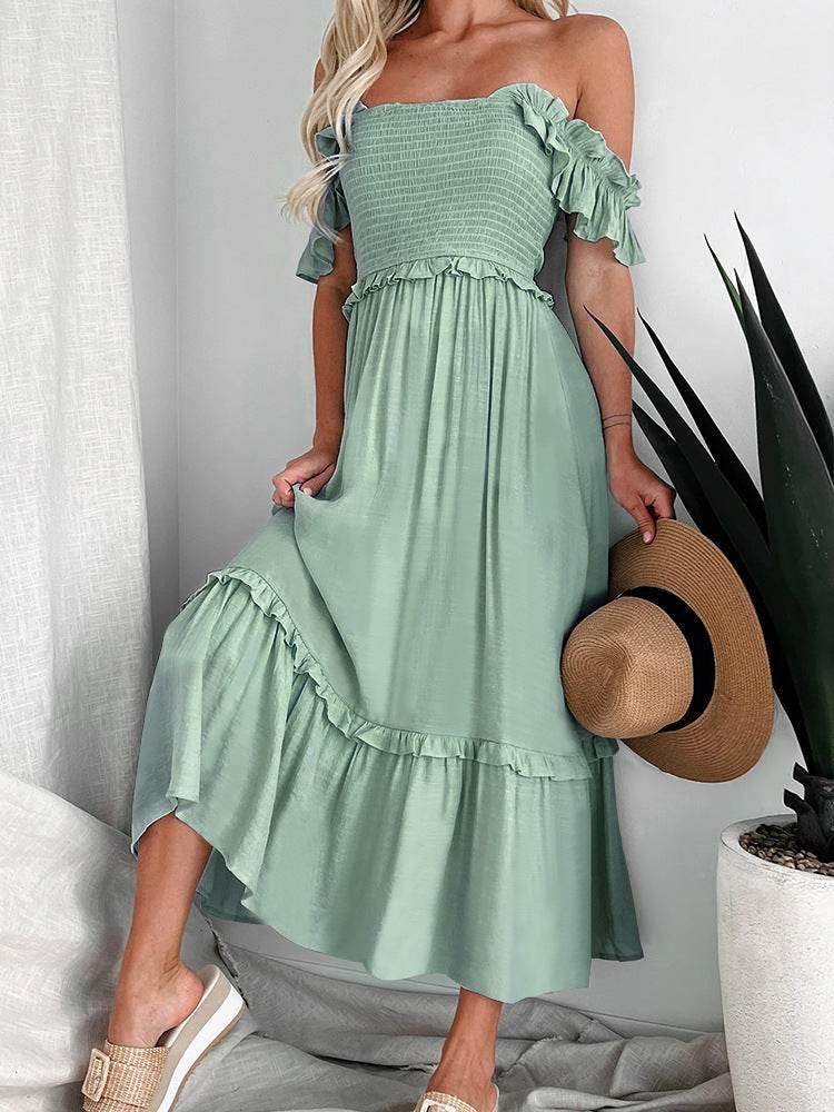 Light green off-shoulder mid-length dress with smocked bodice and ruffled sleeves.