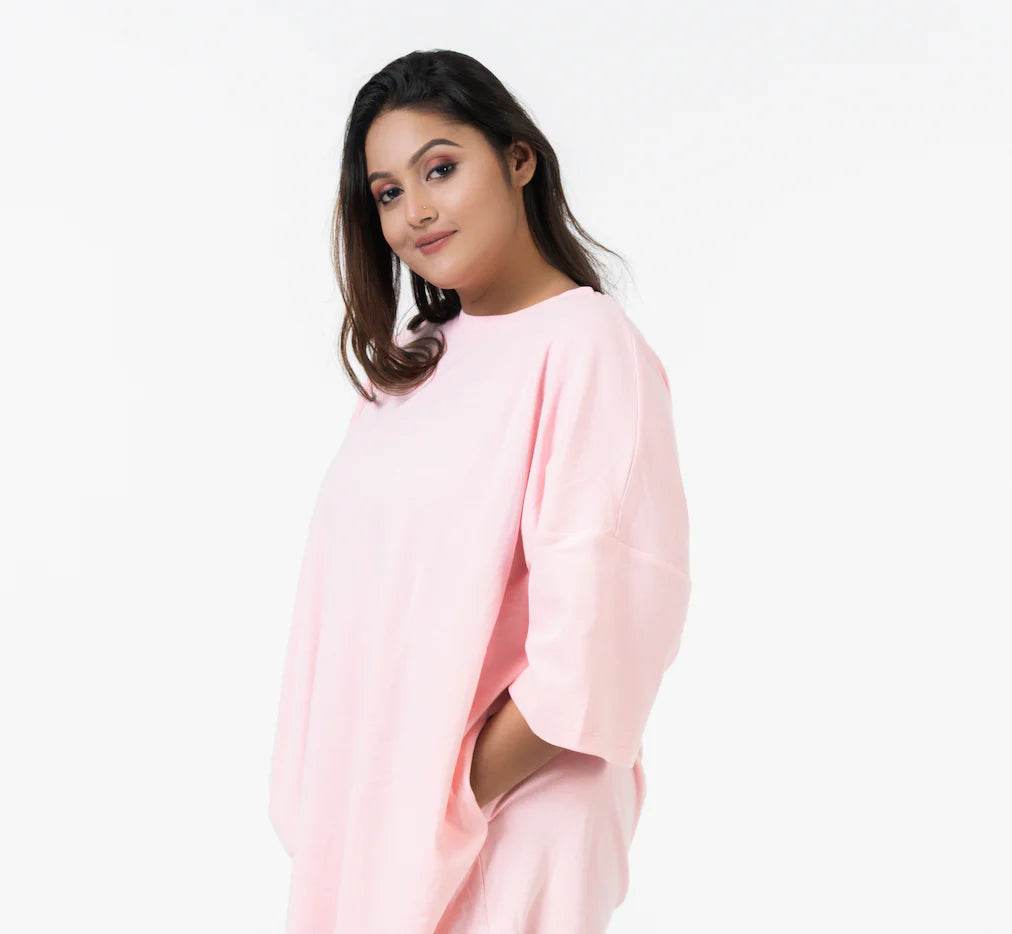 Soft pink relaxed fit T-shirt with short sleeves and a crew neckline worn by a woman.