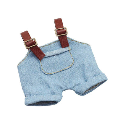 Light blue denim doll overalls with brown adjustable straps and front pocket stitching.