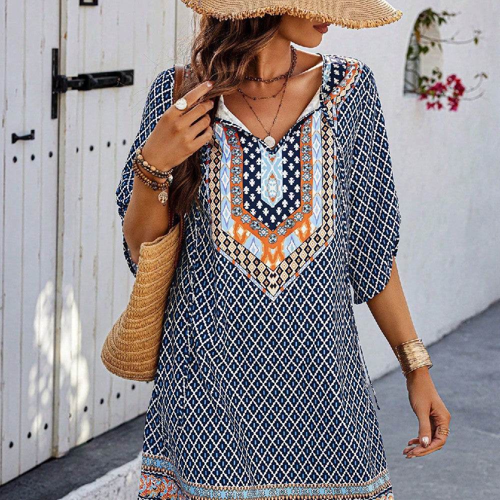Blue casual sling dress with geometric and orange tribal print, loose fit with three-quarter sleeves.