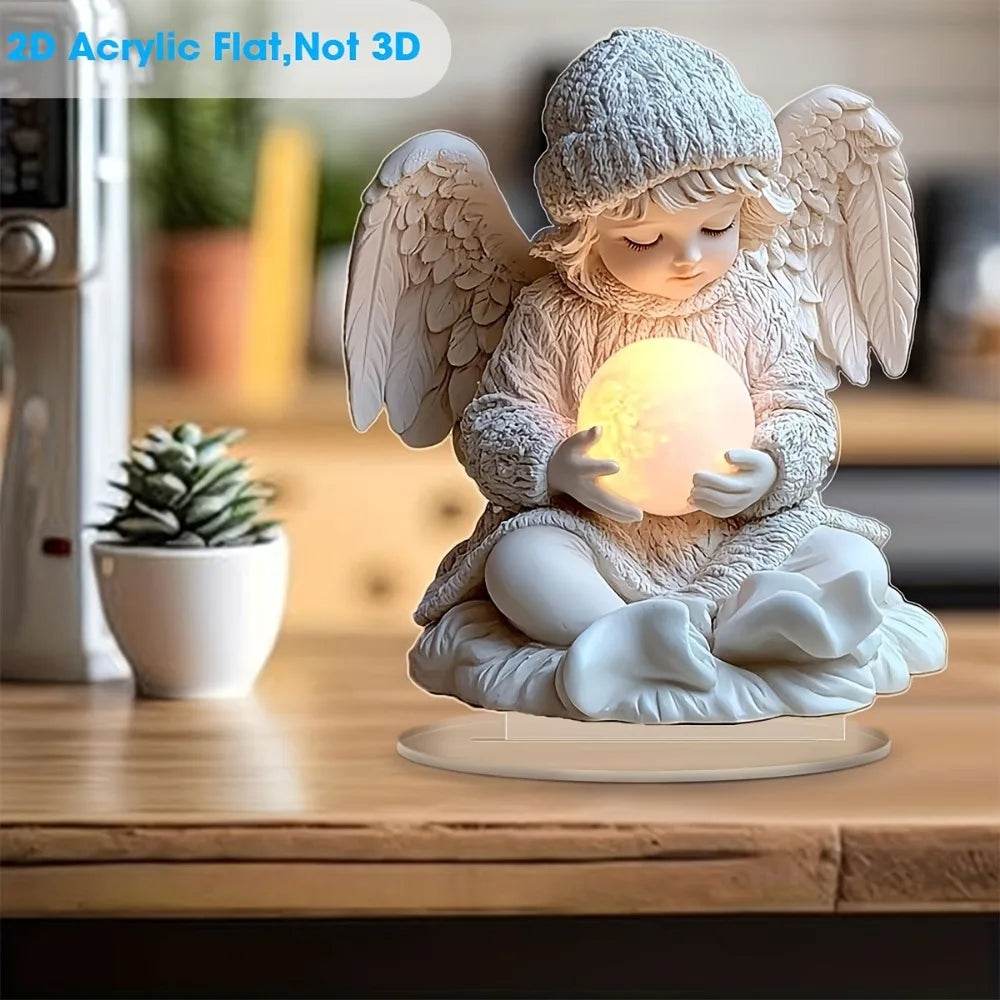 White 2D flat angel figurine holding glowing orb, sitting on round pedestal with knitted hat and wings.