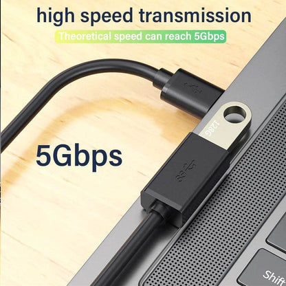 Black USB 3.0 extension cable with male and female connectors plugged into a laptop USB port.