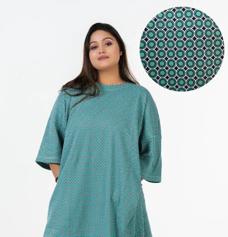 Relaxed fit teal T-shirt with dark circular geometric print and half sleeves.