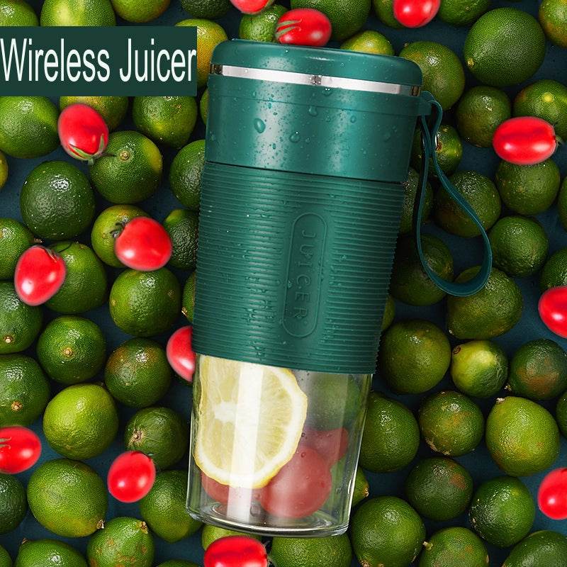 Green portable cordless blender with textured grip and lemon slices inside clear blending jar.