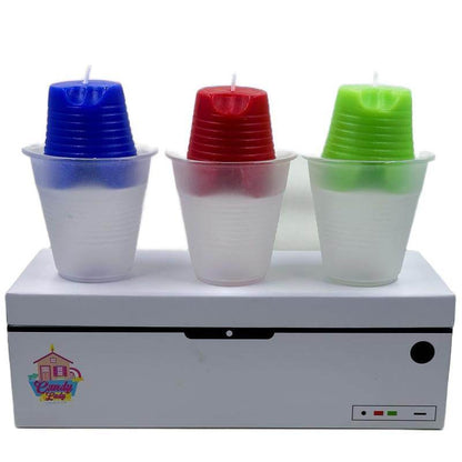 Set of three Huckabuck candles in blue, red, and green, each in a clear plastic cup, on a white box with a colorful logo.