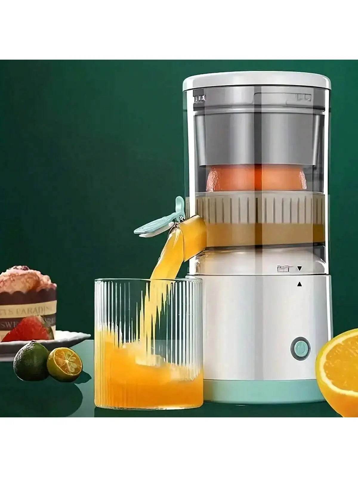 White automatic portable juicer with stainless steel top juicing an orange into a clear glass on a dark green background.