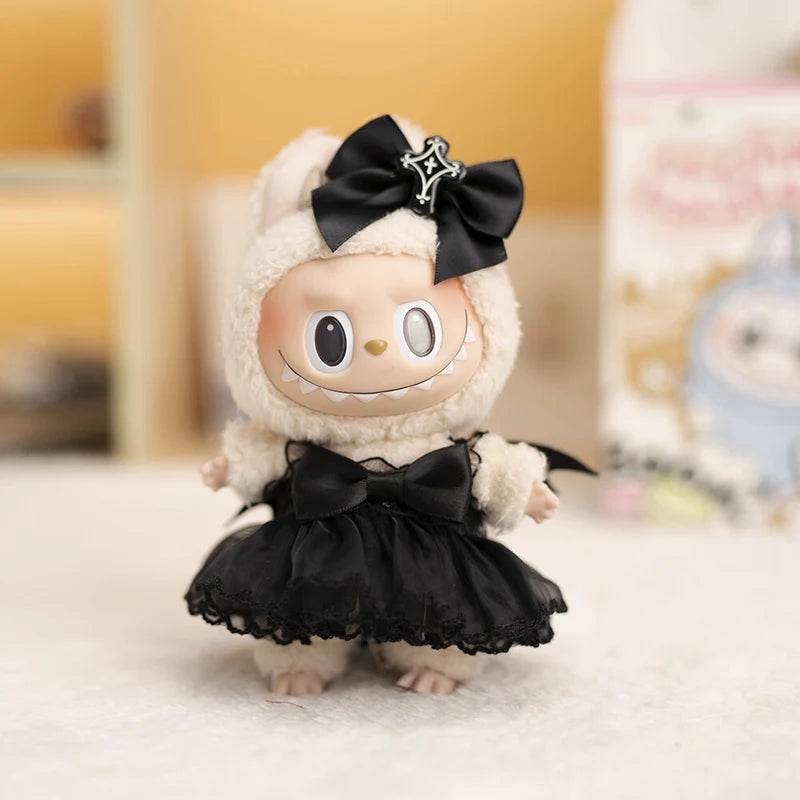 17cm doll dressed in a black satin devil wedding dress with bow and star accessory.