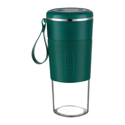 Green portable blender with textured grip, stainless steel accent, and transparent bottom cup with strap handle.
