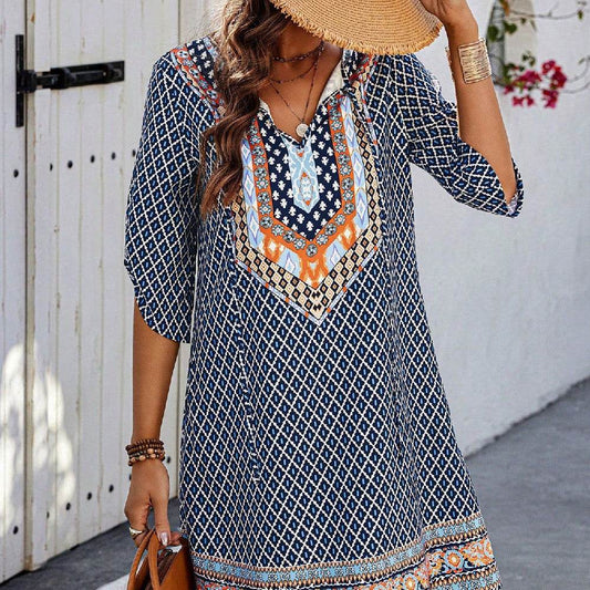 Blue casual dress with geometric and tribal-inspired prints, three-quarter sleeves, and V-neckline with button details.