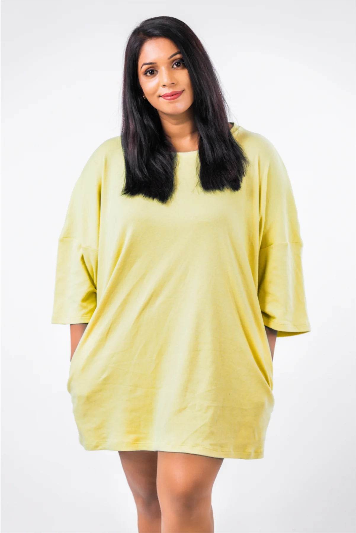 Light yellow oversized relaxed fit t-shirt with drop shoulders and elbow-length sleeves.