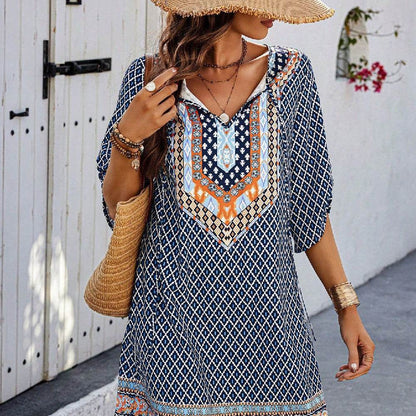 Blue casual sling dress with geometric and tribal print, three-quarter sleeves, and V-neckline.