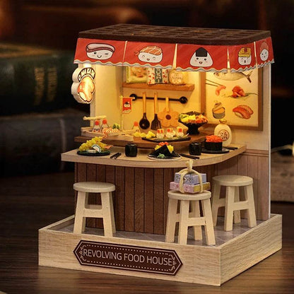 Miniature 3D DIY flower house kitchen with wooden stools, hanging pots, and fruit decals.