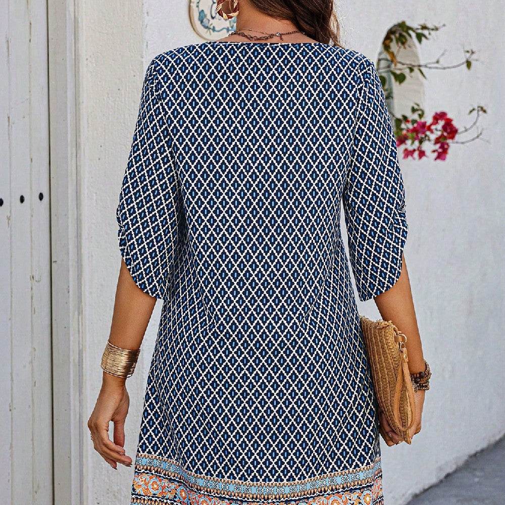 Blue casual women's sling dress with geometric print and three-quarter sleeves.