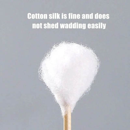 Close-up of a single white cotton swab with a rounded double-ended tip on a gray background.