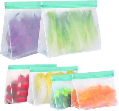 Set of six reusable purple freezer ziplock bags filled with various fresh fruits and vegetables.