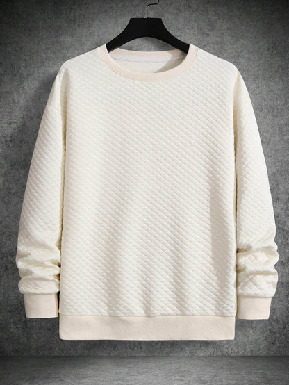Apricot quilted long sleeve sweatshirt with drop shoulders and ribbed cuffs and hem.