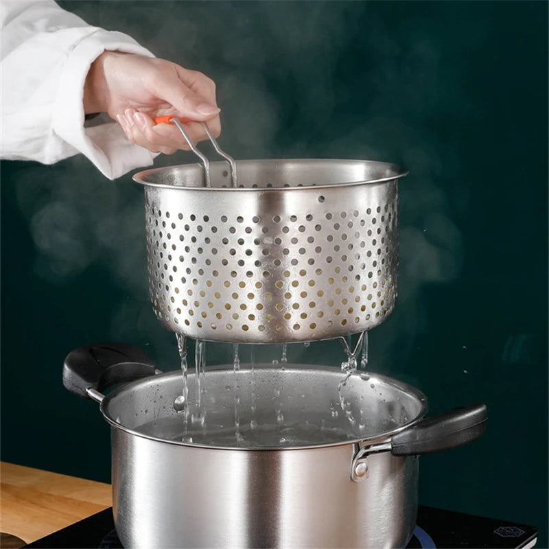 Stainless steel colander being used over a pot with steam rising, on a dark background.