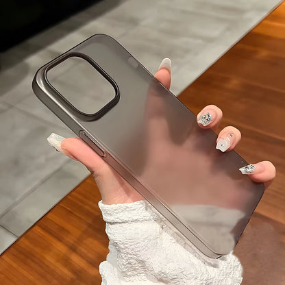 Person holding a reflective phone case on a wooden surface