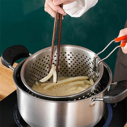 Person using chopsticks to handle food in a perforated metal strainer over a pot.