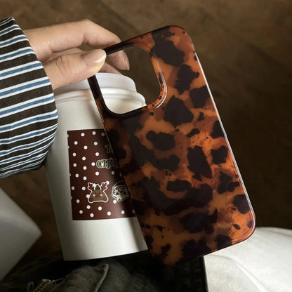 Person holding a thermos with a leopard print handle