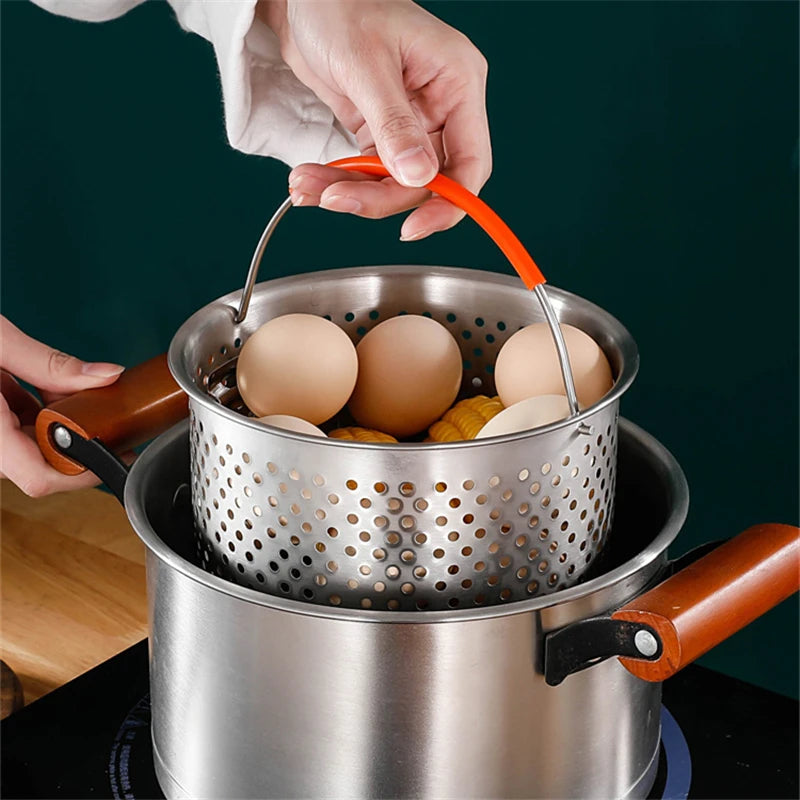 Stainless steel pot with a perforated basket containing eggs on a dark background