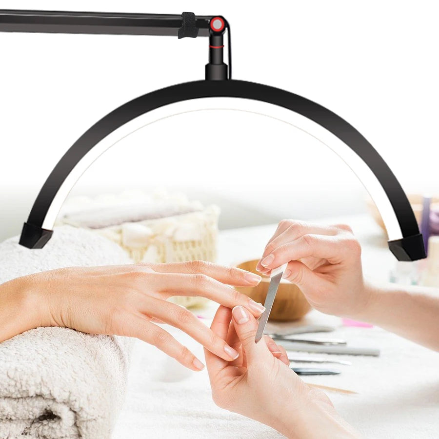 Person getting a manicure with a nail lamp illuminating the hands.