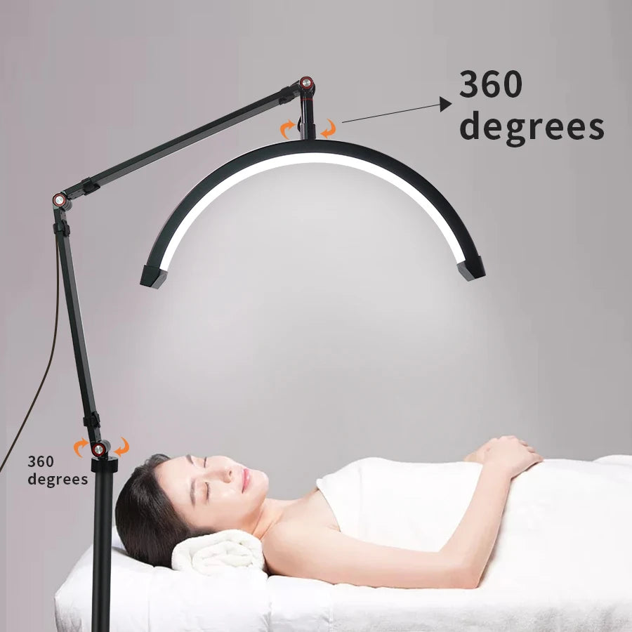 LED lamp with adjustable arm over a person receiving a treatment, on a gray background.
