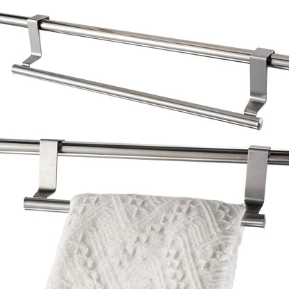 Double towel bar with a white towel hanging on it against a white background