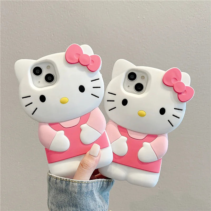 Two cartoon cat phone cases with pink bows held against a gray background