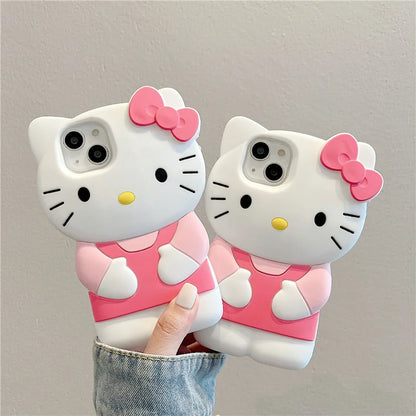 Two cartoon cat phone cases with pink bows held against a gray background