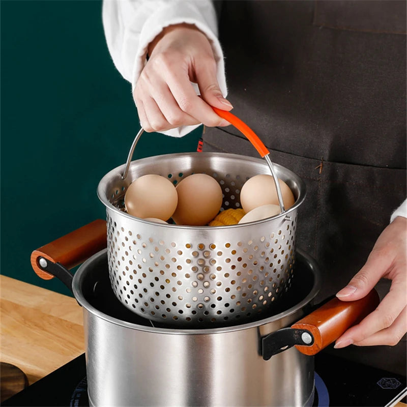 Person holding a metal colander with eggs over a pot on a stove.