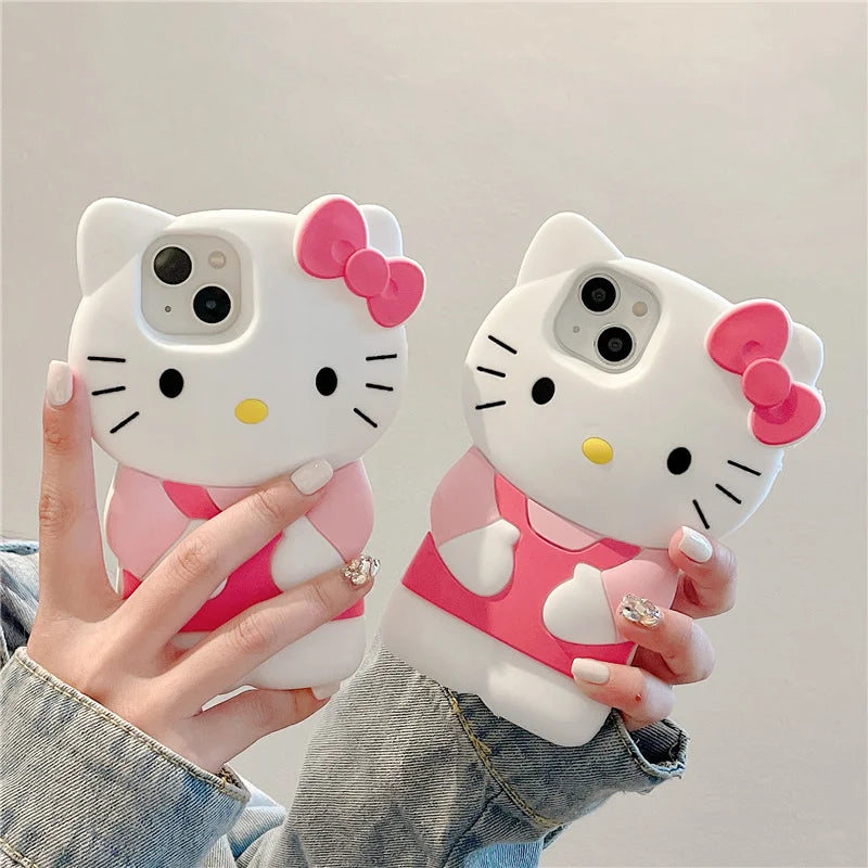 Two Hello Kitty phone cases held by a person against a neutral background