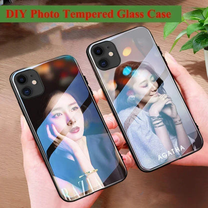 Two phone cases with personalized photos held by hands on a wooden surface.