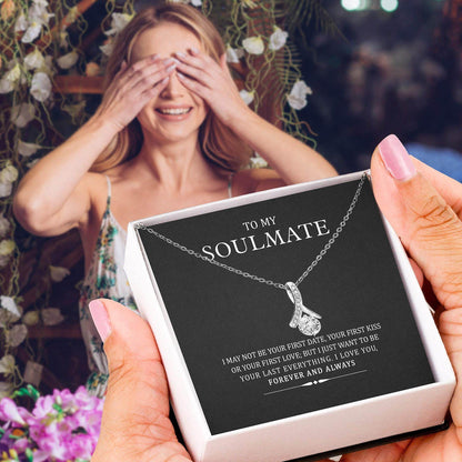 Silver tangled heart pendant necklace on black card in white gift box held by hand.