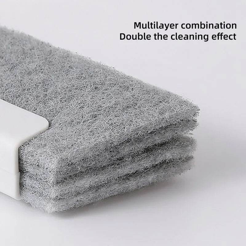 Gray multilayered microfiber cleaning pad with white plastic handle edge, designed for grooves and crevices.