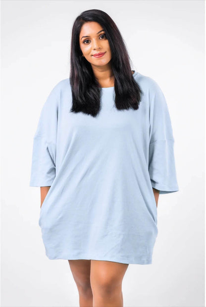 Light blue oversized relaxed fit t-shirt dress with dropped shoulders and mid-thigh length.